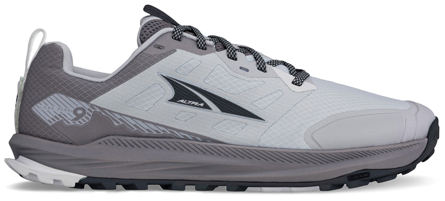 A light grey and dark grey athletic trail running shoe with a thick midsole, rugged tread, and the word Altra printed on the side.