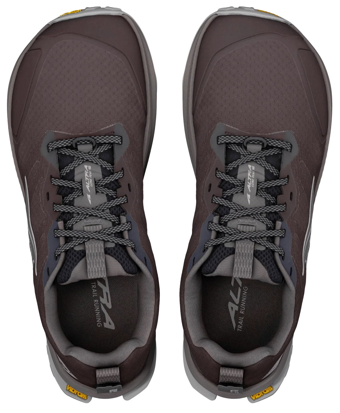 A top-down view of a pair of dark brown trail running shoes with grey laces, grey inner linings, and yellow Vibram brand logos on the heels.