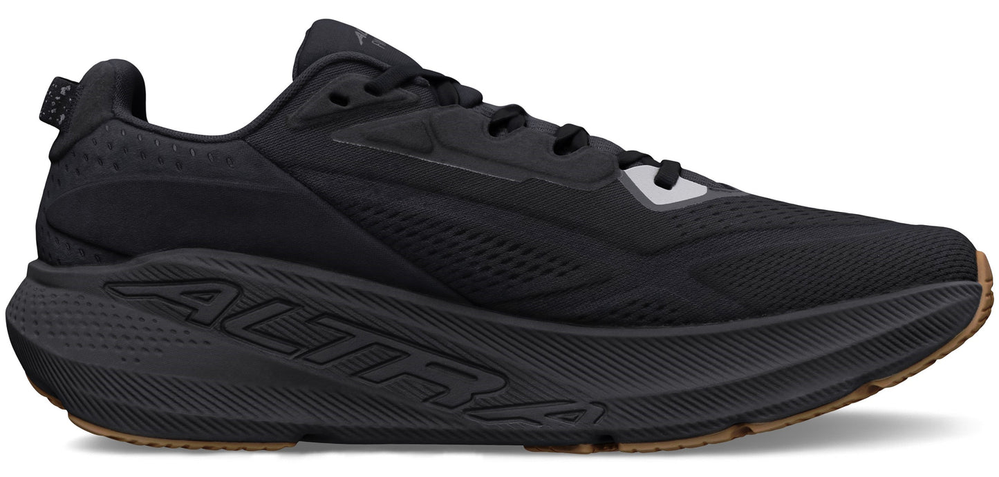 A black running shoe with thick sole.