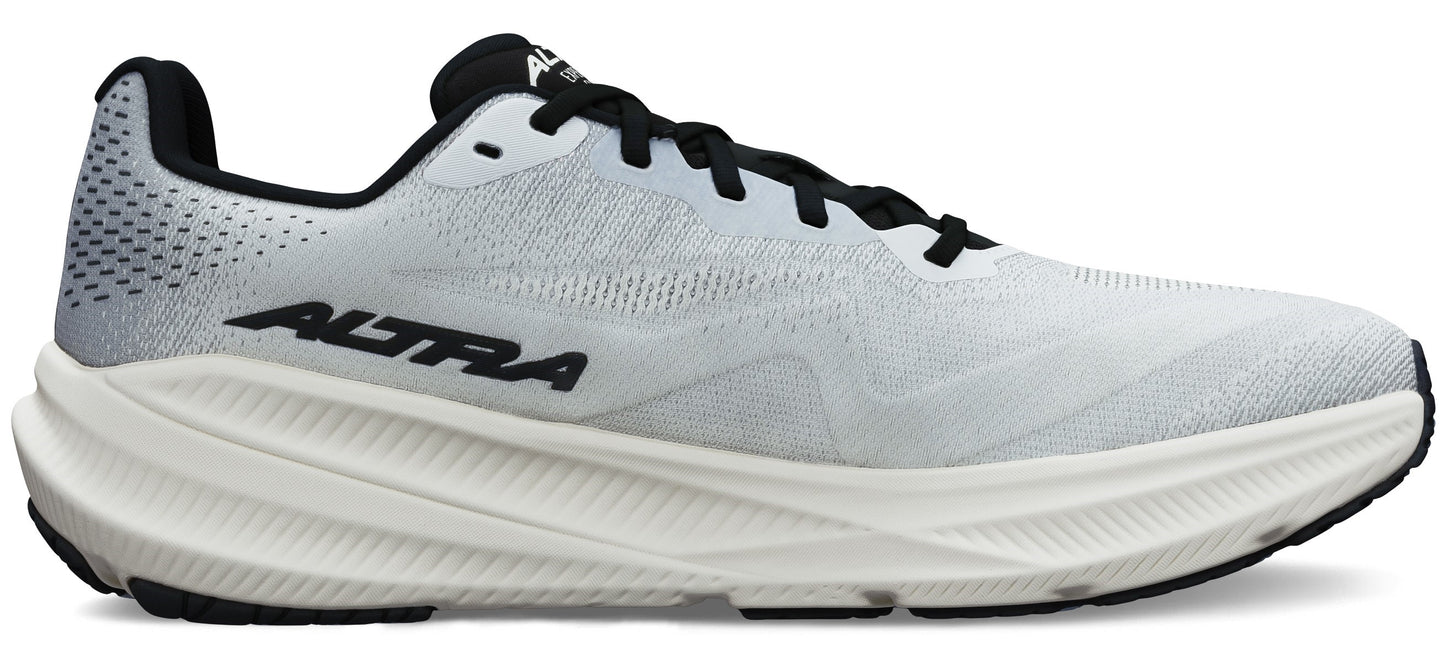 A white running shoe with black laces and sole.