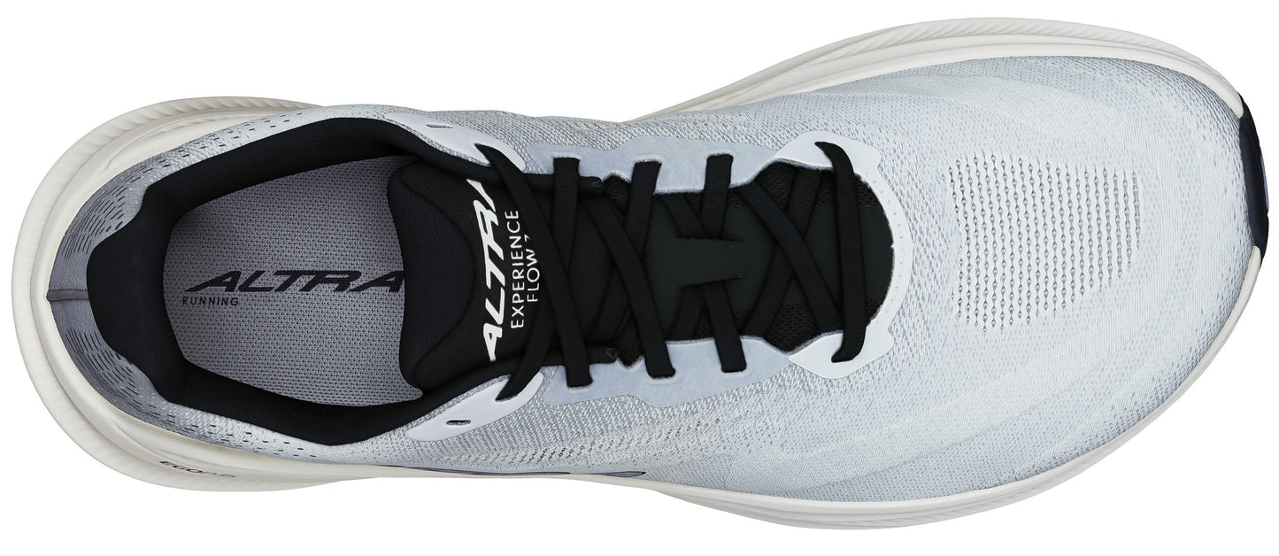 Overhead view of a white running shoe with black laces and the text "ALTRA EXPERIENCE FLOW" on the tongue.