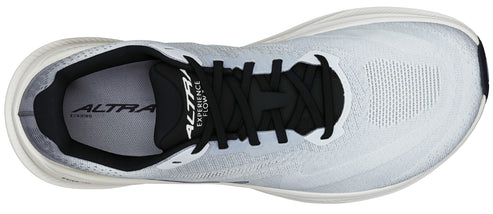 Overhead view of a white running shoe with black laces and the text "ALTRA EXPERIENCE FLOW" on the tongue.