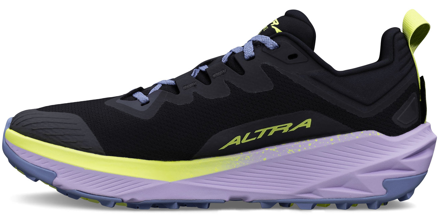 A side view of a black sneaker with light purple accents and a yellow stripe.