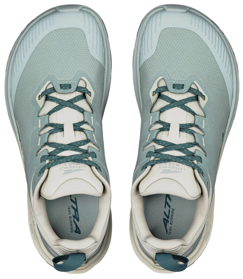 A pair of light sage green trail running shoes viewed from directly above, featuring a wide toe box, speckled dark green laces, beige interior, and a heel pull tab.