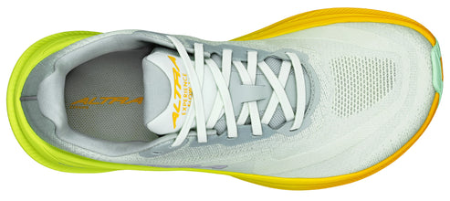Top-down view of a running shoe featuring white laces, a breathable mesh upper, and a yellow outsole.