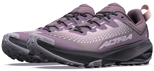 A pair of mauve-colored Altra trail running shoes with dark gray soles and black laces, featuring Vibram branding on the sole and toe cap, shown in a side profile view.