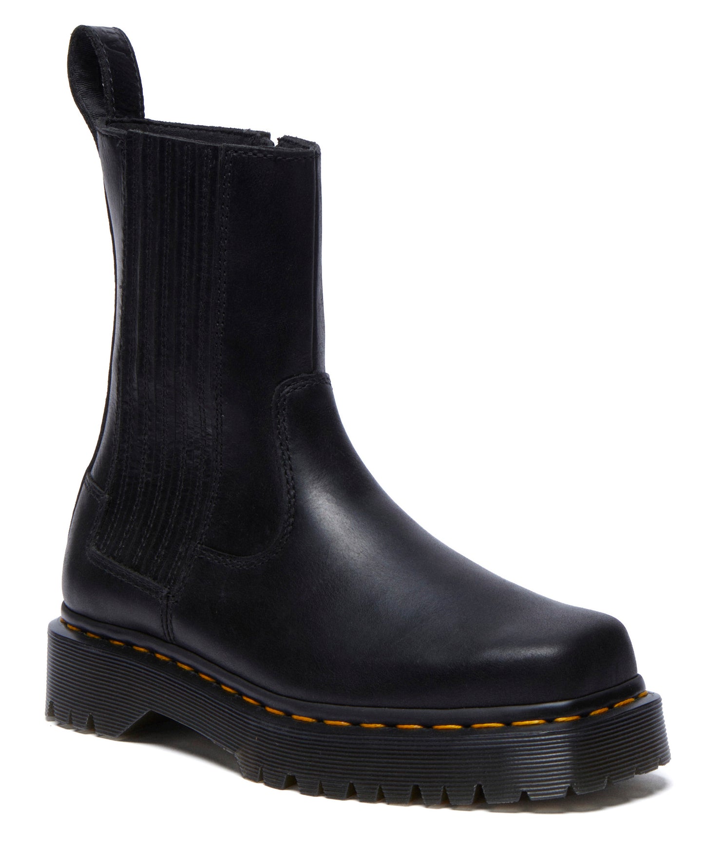 Black leather Chelsea boot with yellow stitching and a thick platform sole.