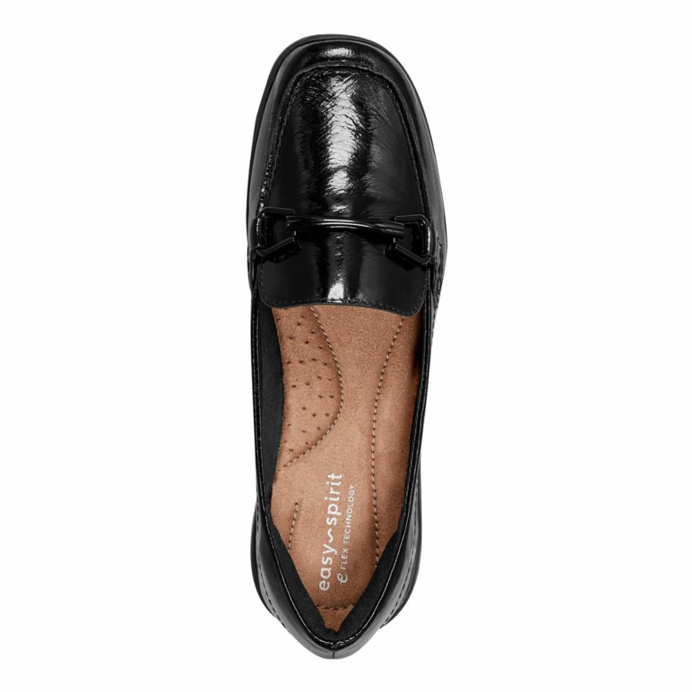 Black shiny loafer with a decorative strap, interior view showing insole with printed text.