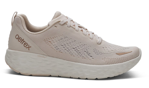 Light beige running shoe with thick sole and 'aetrex' on side.