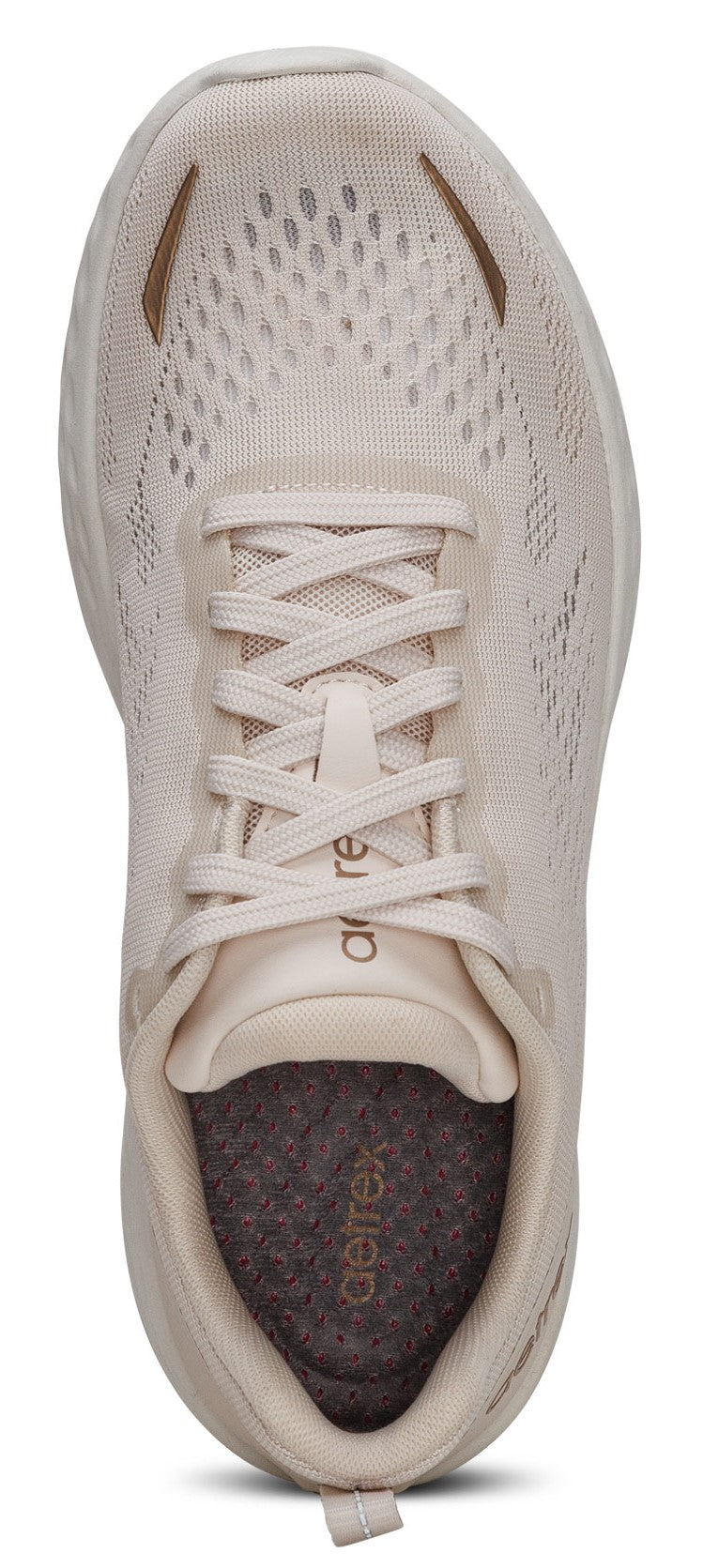 A close-up of a light colored sneaker, laces visible, with the brand name visible near the shoe tongue.