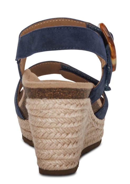 Back view of a navy espadrille wedge sandal with an ankle strap and tortoise buckle.