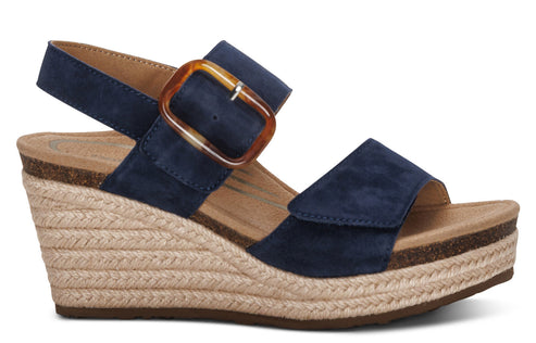 Navy suede wedge sandal with a jute-wrapped heel and a buckle closure.