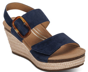 A blue wedge sandal with adjustable straps and a decorative buckle.