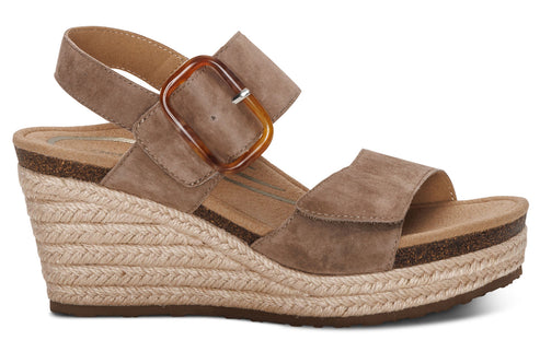 Wedge sandal with espadrille rope trim and adjustable ankle strap and buckle.