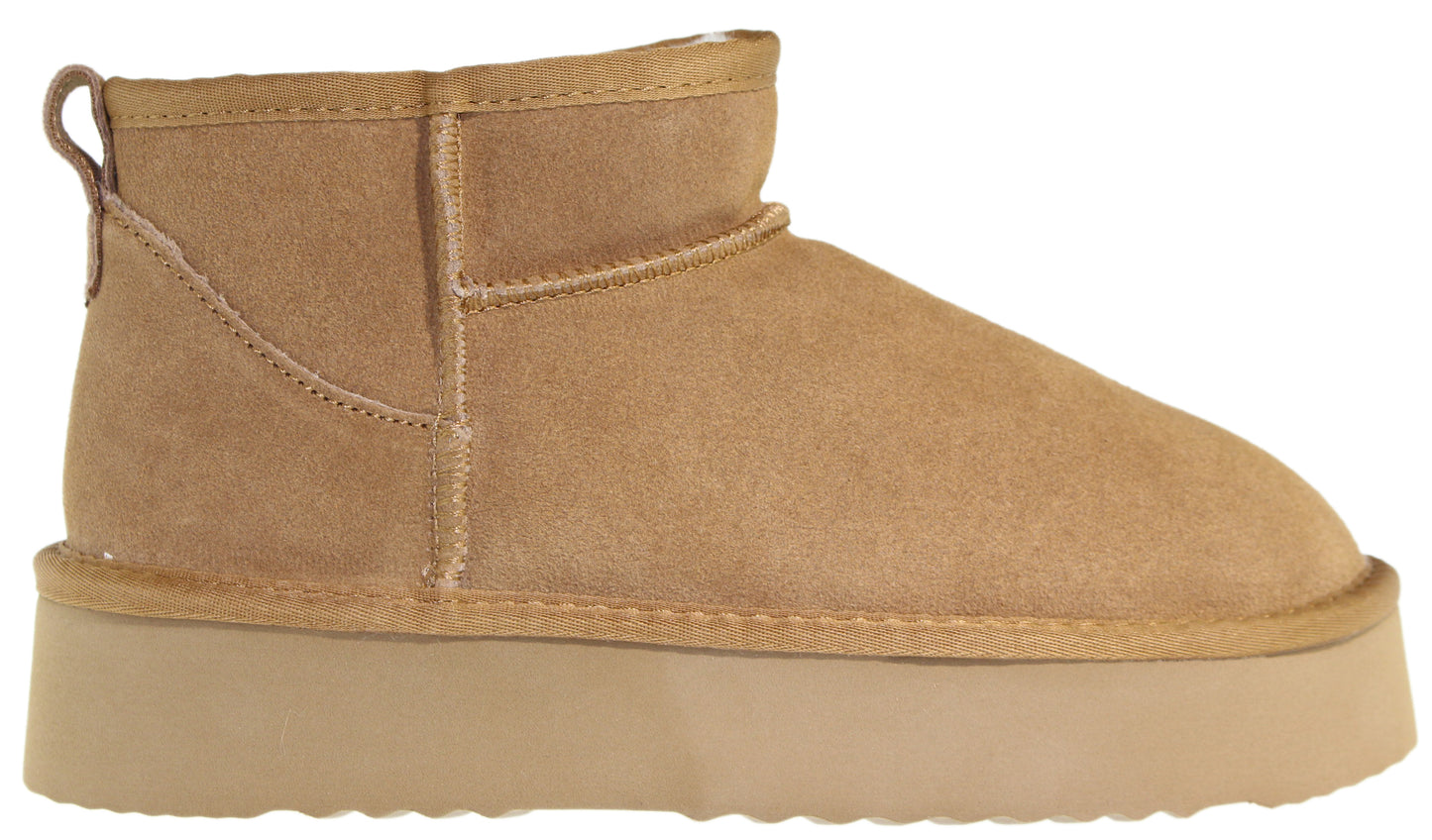 Tan ankle-high suede boot with a thick, platform sole.