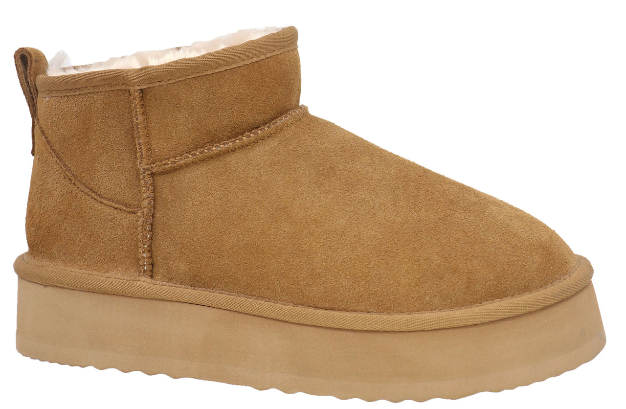 A short, chestnut-colored boot with a thick, flat sole and furry white lining.