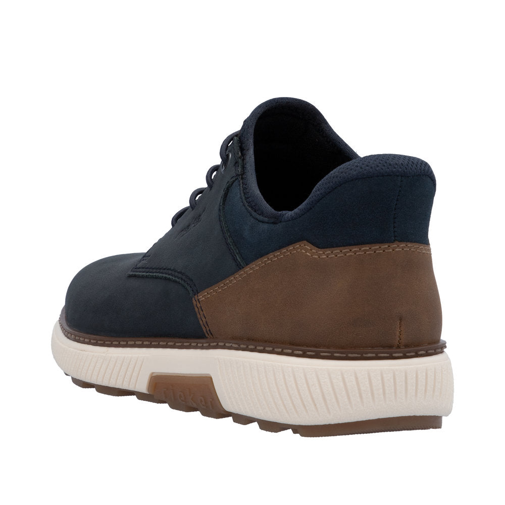 Low top shoe with navy upper, brown accent, and white ridged sole.