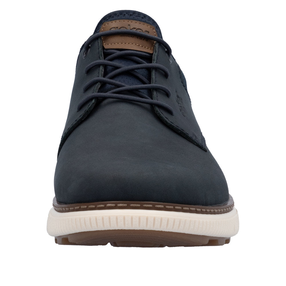 Front view of a dark blue dress shoe with brown accents and white soles