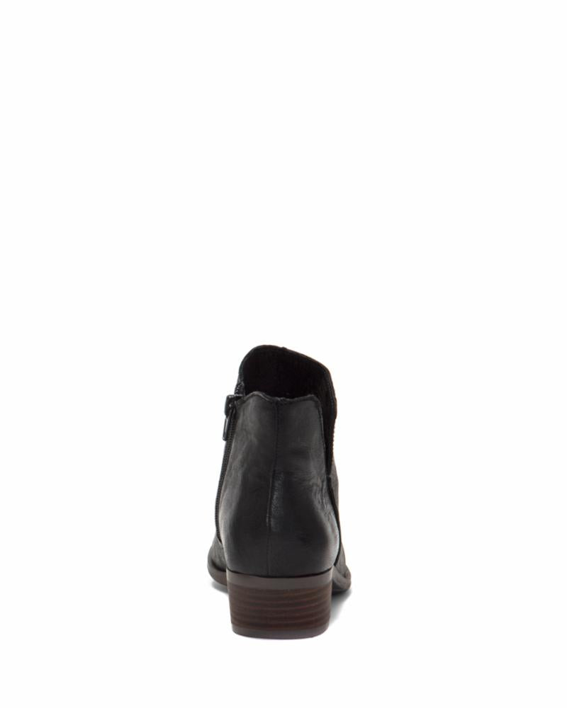 Back view of a black ankle boot with a stacked heel and side zipper.