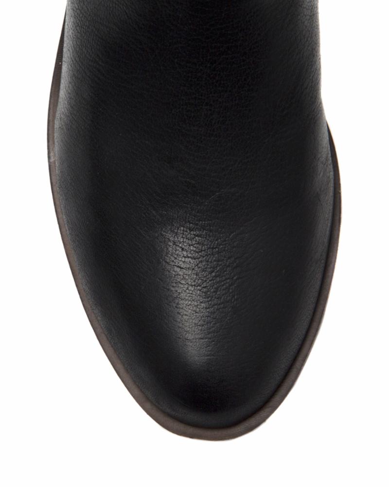 Close-up of the toe of a black boot.