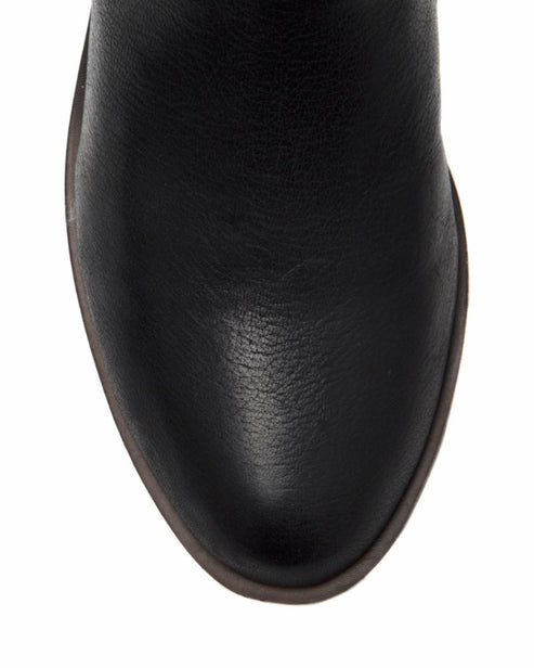 Close-up of the toe of a black boot.