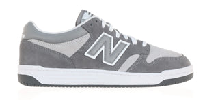 A gray sneaker with a white sole and 'N' logo.