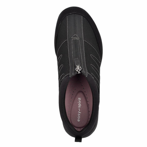 Black slip-on shoe with zipper closure and light pink insole, seen from above.