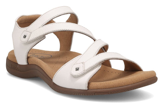 White sandal with velcro straps and a brown sole.