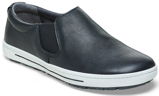 A black leather slip-on shoe with a thick white rubber midsole and black non-slip outsole, featuring side elastic panels for a flexible fit.