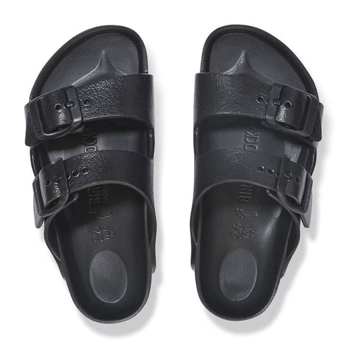 Overhead view of two black, two-strap, adjustable-buckle sandals.