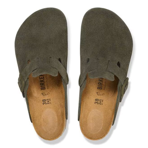 Two olive green suede clogs with a buckle on the side and the size and some text visible on the insole, viewed from above.