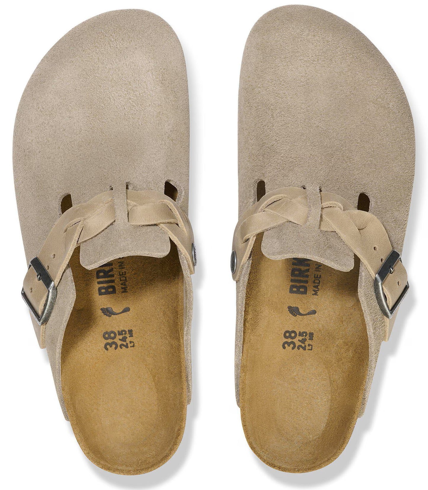 A pair of taupe suede slip-on shoes with a braided strap and silver buckle across the top, featuring a contoured footbed with size 38 markings.