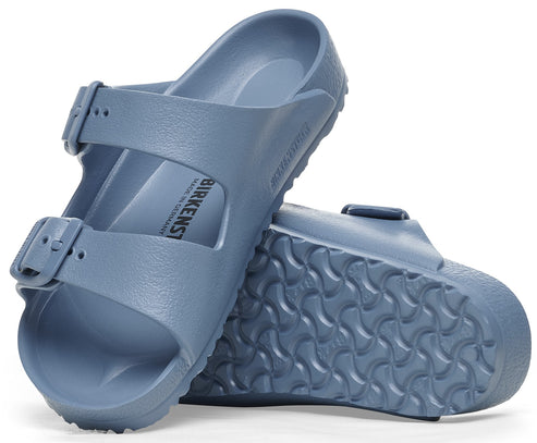 Two blue adjustable buckle sandals, one stacked on the other, showing the contoured footbed and tread.