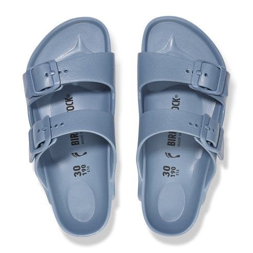Pair of two-strap blue sandals with buckles.