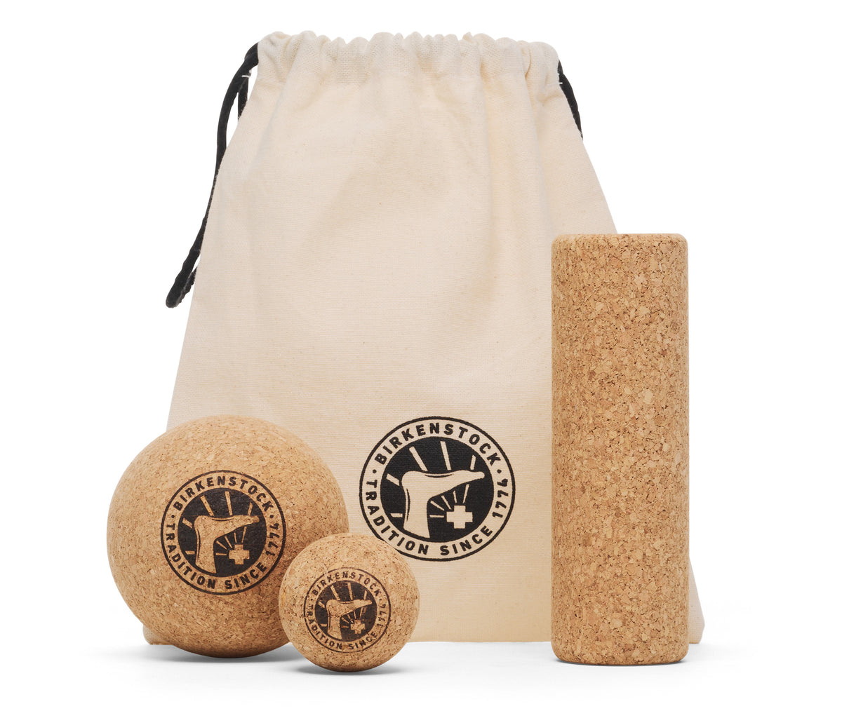 Cork massage set with a bag and two balls of different sizes, plus a long roller. Visible text on the balls says "TRADITION SINCE 1774"