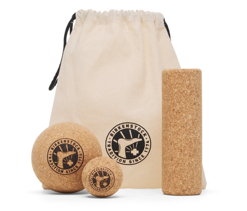 Cork massage set with a bag and two balls of different sizes, plus a long roller. Visible text on the balls says "TRADITION SINCE 1774"