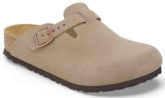 Tan suede clog with buckled strap, cork midsole, and dark brown sole.