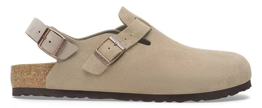 Beige clog-style shoe with adjustable strap and buckle.