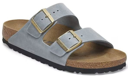 Two-strap slip-on sandal with adjustable brass buckles.