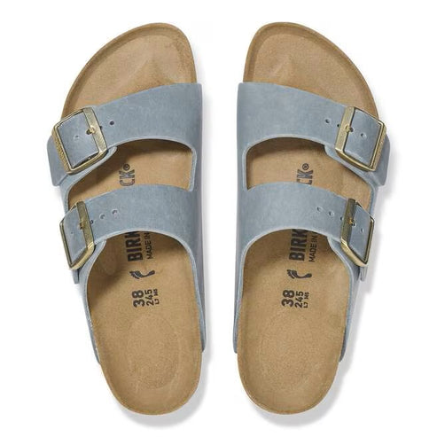 Two light blue sandals with gold buckles.