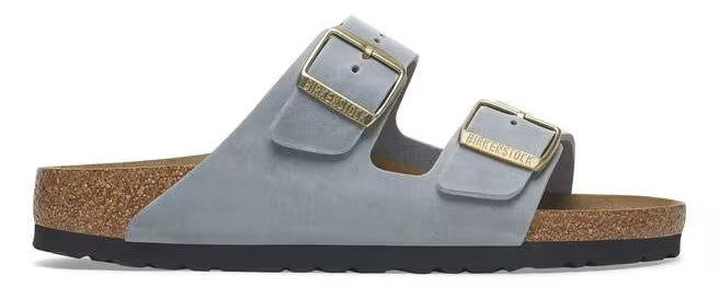 A pair of gray, two-strap sandals with gold buckles and a cork footbed.