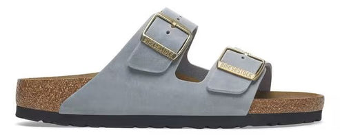 A pair of gray, two-strap sandals with gold buckles and a cork footbed.