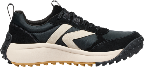 Black sneaker with beige accent and thick beige sole with black tread.
