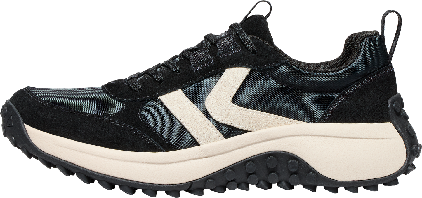 A black sneaker with a white logo and a thick, off-white sole.