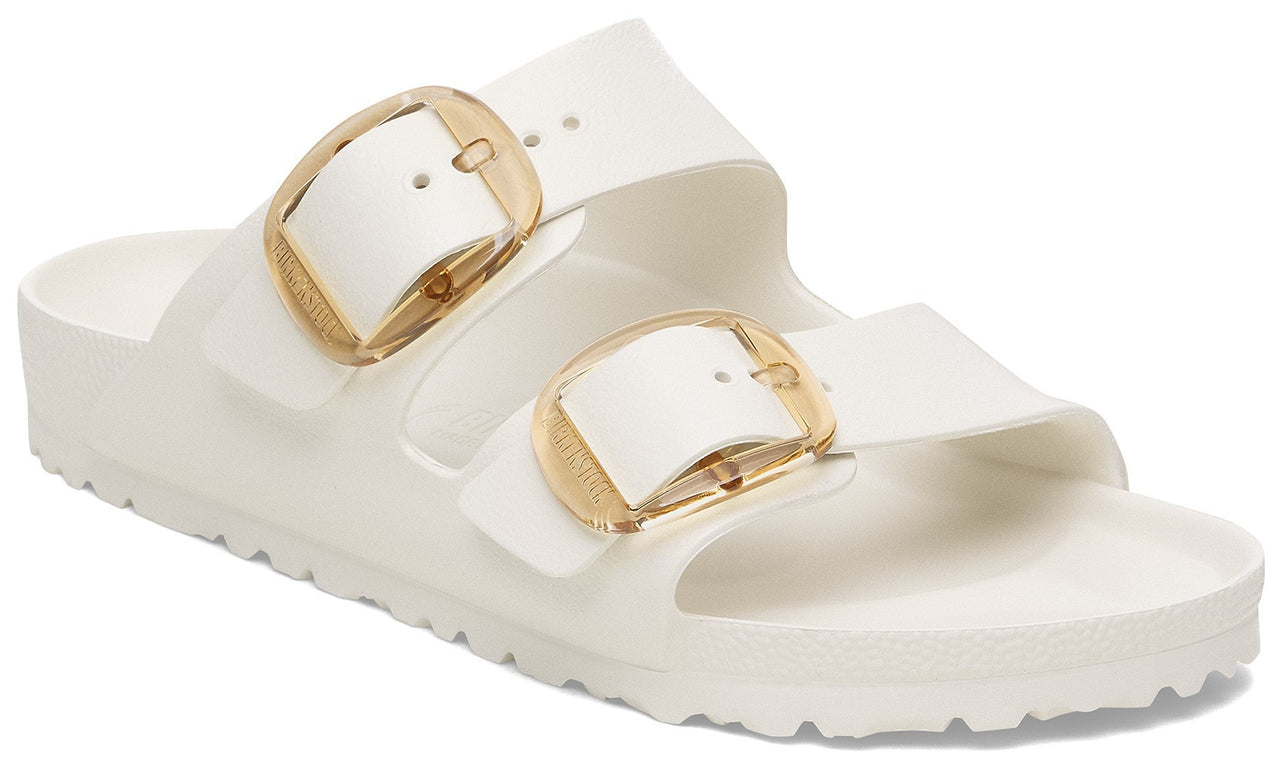 White sandal with large gold buckles.