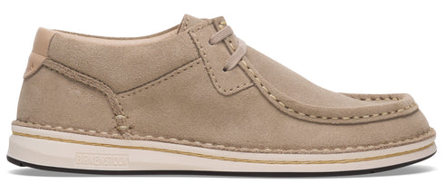 Tan-colored, low-top moccasin shoe with a white sole and laces.