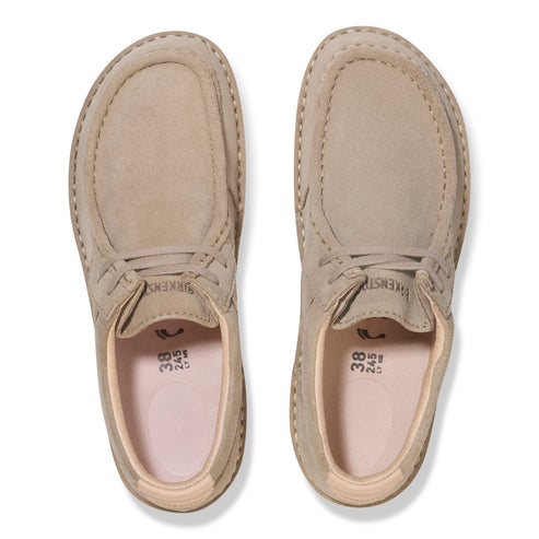 A pair of tan suede shoes with rounded toes and visible stitching, viewed from above.
