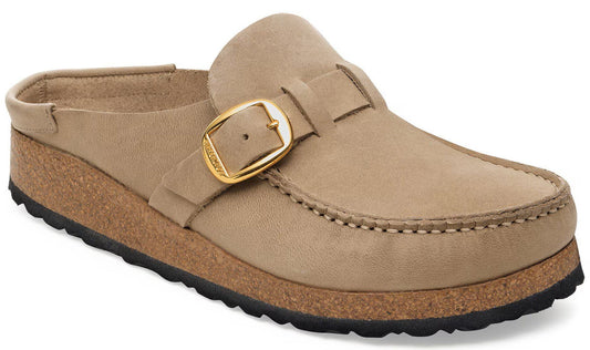 A tan suede slip-on shoe with a round toe, an adjustable gold-toned buckle across the top, a cork-textured midsole, and a black ridged outsole.