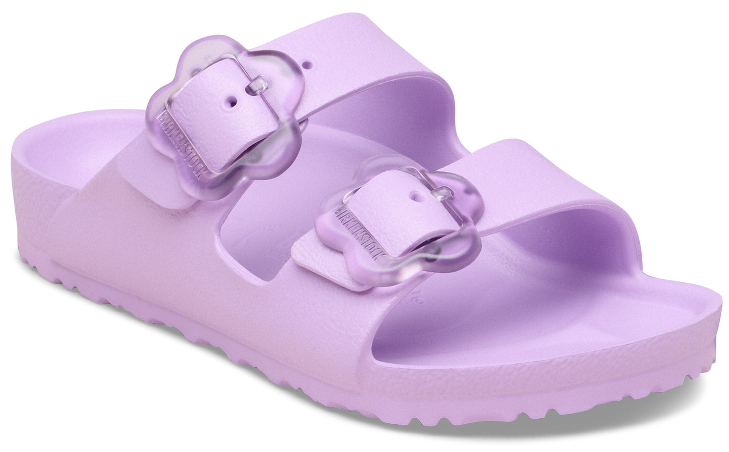 Lavender slide sandals with two straps, each with a flower-shaped buckle.