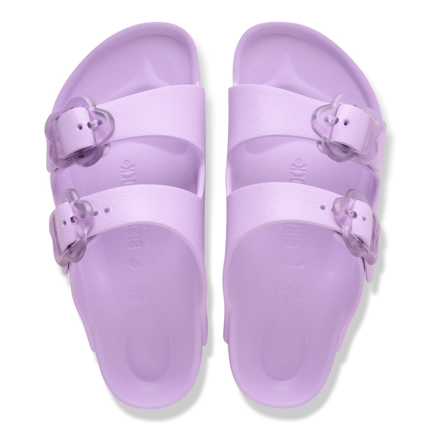 Two purple slide sandals with adjustable straps and translucent buckles.